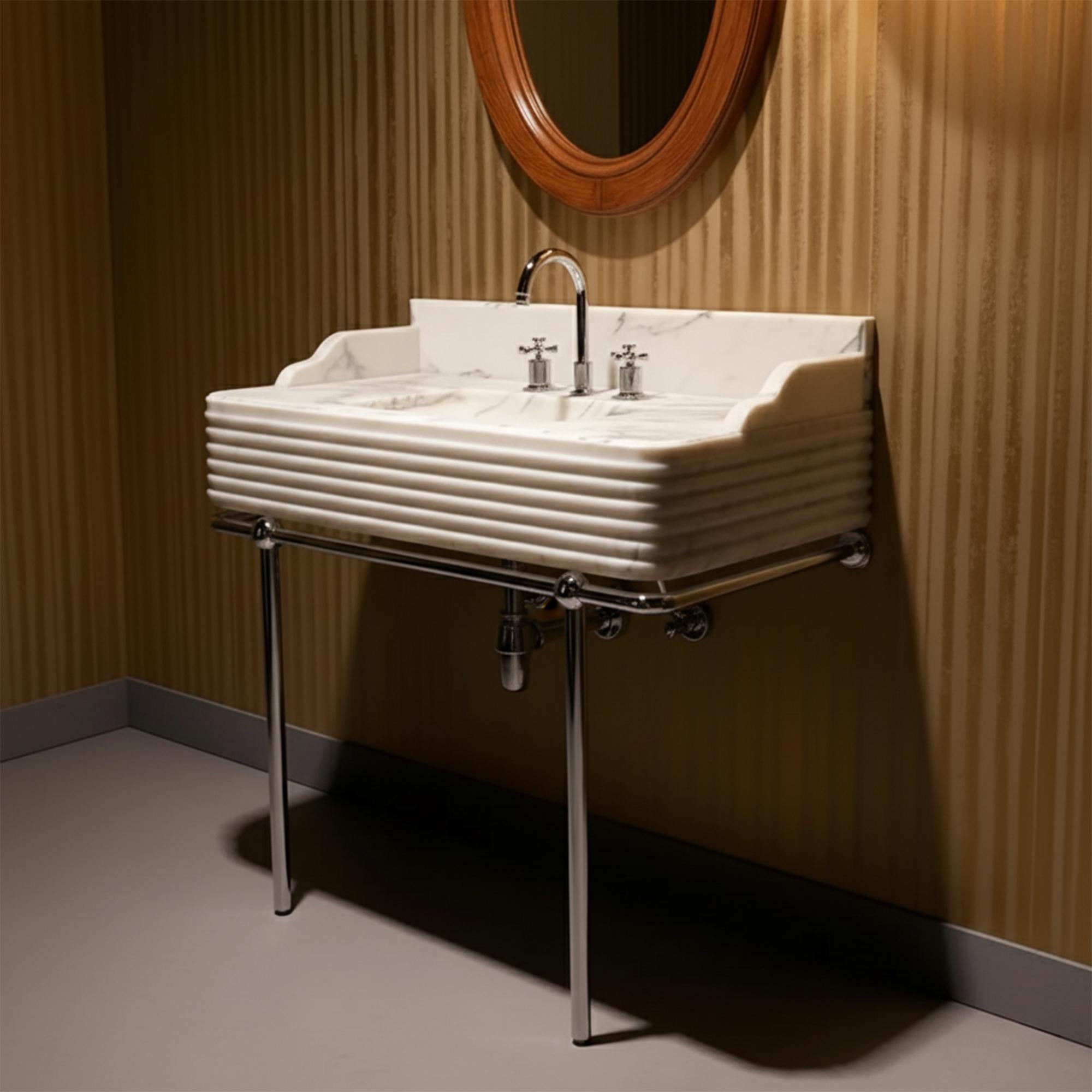 A luxurious fluted Carrara marble vanity sink with polished chrome legs, ideal for high-end modern and classic bathrooms.