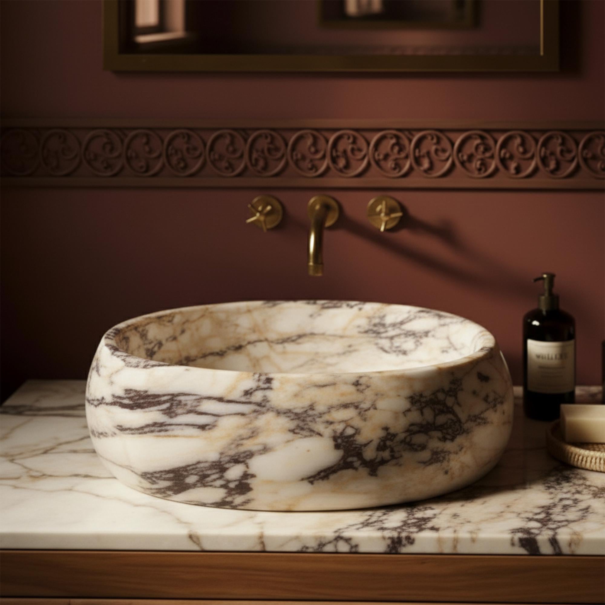 The soft tones of Calacatta marble blend beautifully with the natural texture of woven rattan in this upscale bathroom console.