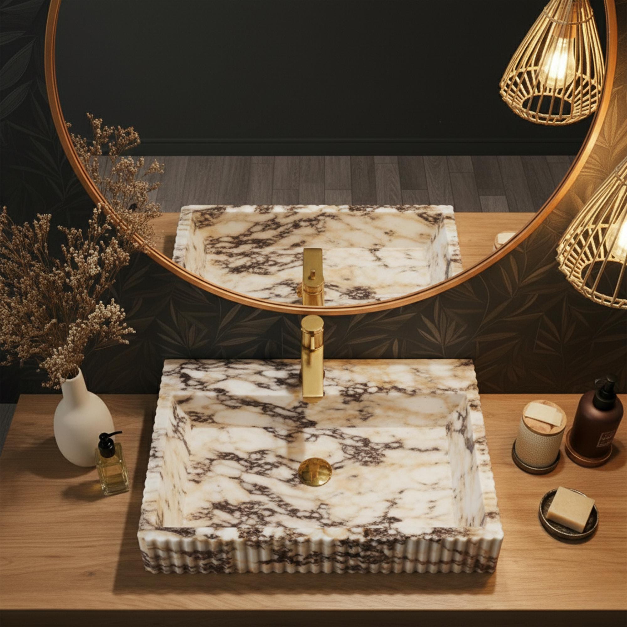 An elegant Calacatta Amber Viola marble sink showcases fluted edges and timeless style in a high-end vanity setup.
