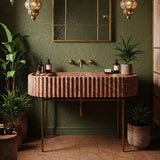 This image shows a Rosso Levanto fluted marble sink paired with a brass frame, styled in an elegant, nature-inspired luxury bathroom.
