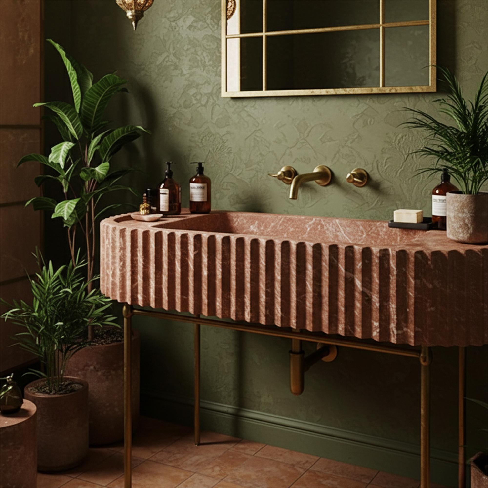 The sculptural red marble vanity with vertical fluting stands out against the green wall, creating a bold and refined statement in the bathroom.