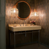 This rustic fluted travertine vanity sink adds earthy luxury to a farmhouse-style bathroom with timeless beige stone and chrome fixtures.