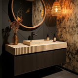 The image showcases a fluted travertine vessel sink resting on a rustic wall-mounted vanity, blending modern luxury with earthy elegance.